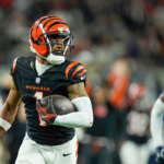 Ja'Marr Chase of the Cincinnati Bengals runs away from a Dallas defender after making a catch against the Cowboys.