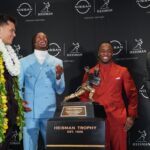 Dillon Gabriel, Travis Hunter, Ashton Jeanty, and Cam Ward pose with the Heisman Trophy.