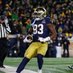 Notre Dame's Jayden Thomas is shown scoring a touchdown.
