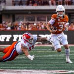 Quinn Ewers runs the ball for Texas.