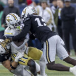 Vanderbilt and Georgia Tech players collide in action.
