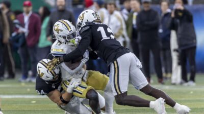 Vanderbilt and Georgia Tech players collide in action.