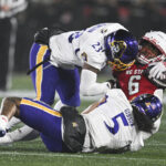 ECU and NC State players in action.