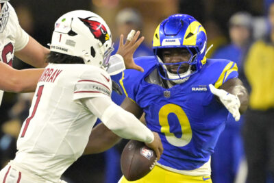 Byron Young rushes the passser.