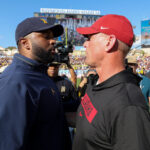 Alabama head coach Kalen DeBoer and Michigan head coach Sherrone Moore shake hands