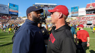 Alabama head coach Kalen DeBoer and Michigan head coach Sherrone Moore shake hands
