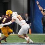 Michael Taaffe lays a hit for Texas.