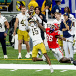 Leonard Moore is shown defending a pass.