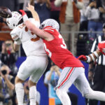 Quinn Ewers gets hit by Jack Sawyer late in the Cotton Bowl.