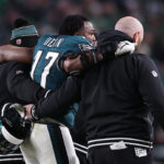 Nakobe Dean exits the Wild Card game against Green Bay.