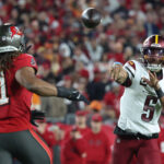 Jayden Daniels fires a pass.