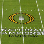 College Football Playoff National Championship logo painted on field at Raymond James Stadium.