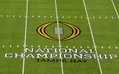 College Football Playoff National Championship logo painted on field at Raymond James Stadium.