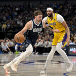 Luka Doncic drives with the ball against Anthony Davis.