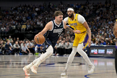 Luka Doncic drives with the ball against Anthony Davis.