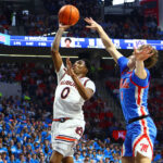 Auburn and Ole Miss players in action.
