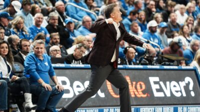 John Calipari celebrates after a big play in Arkansas's win over Kentucky.