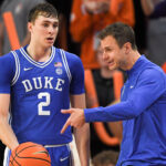 Cooper Flagg and Jon Scheyer talk during a game against Clemson.