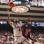 Johni Broome battles for a rebound.