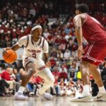 Auburn guard Denver Jones dribbles the ball during a game against Alabama.
