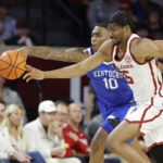 Oklahoma and Kentucky players fight for a loose ball.