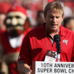 Jon Gruden speaks at a Buccaneers game.