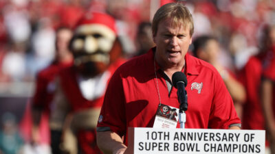 Jon Gruden speaks at a Buccaneers game.