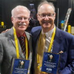 Brett Friedlander, right, and Gary Hahn, left, receive the Skeeter Francis Award.