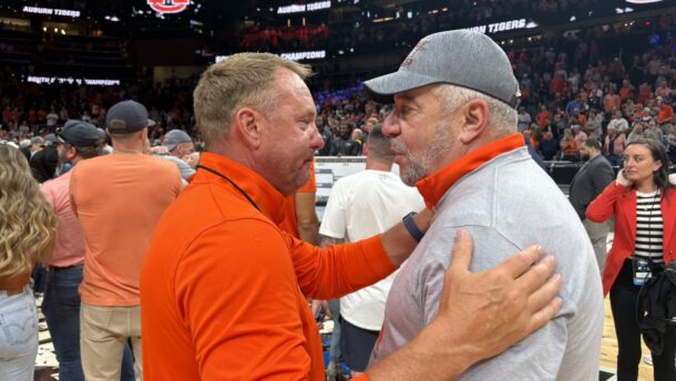 Hugh Freeze and Bruce Pearl embrace.