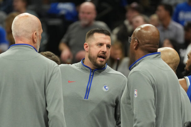 Luke Loucks is shown talking to other Kings coaches.