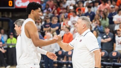 Bruce Pearl and Dylan Cardwell embrace.