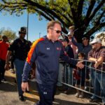 Hugh Freeze walks.
