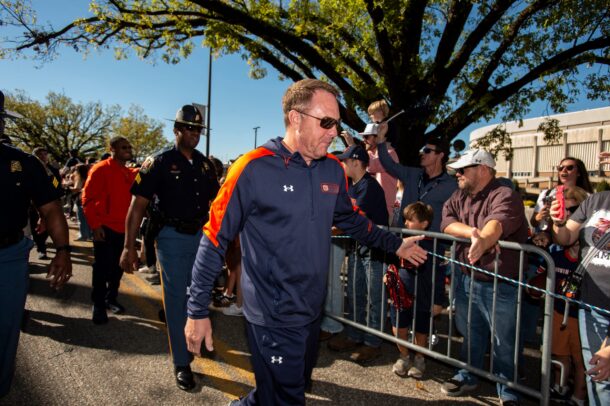 Hugh Freeze walks.