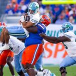 Desmond Watson makes a tackle.