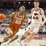 Tre Johnson drives the ball past Zvonimir Ivisic.