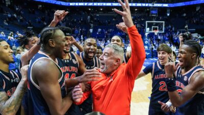 Auburn head coach Bruce Pearl and players celebrate.