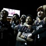Wade Taylor and his teammates react to his jersey being honored at Texas A&M.