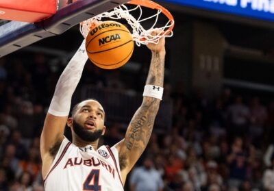 Johni Broome is shown dunking the basketball for Auburn.