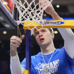 Duke's Cooper Flagg cuts down the net at the ACC Tournament.