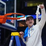 Todd Golden shown cutting down the net.