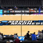 NCAA Tournament March Madness logo shown on court.