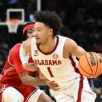 Mark Sears of Alabama dribbles the ball past a Robert Morris defender.