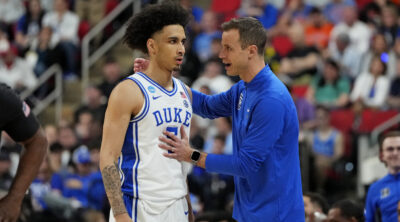Duke's Tyrese Proctor and Jon Scheyer have a talk on the court during the NCAA Tournament.