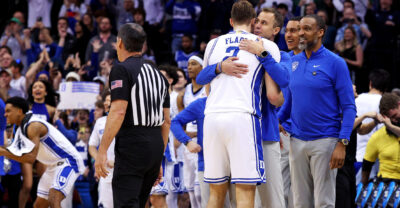 Duke's Jon Scheyer and Cooper Flagg hug after a win over Alabama.