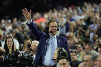 Jim Nantz waves to the crowd.