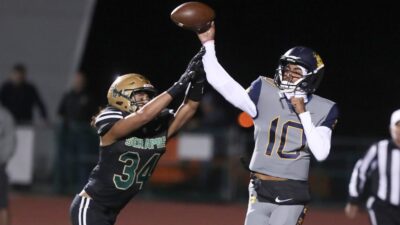 Madden Iamaleava throws a pass in a high school game.