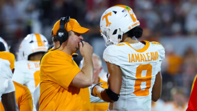 Josh Heupel speaks to Nico Iamaleava during a game.