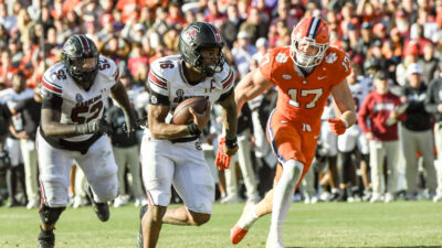 LaNorris Sellers carries the football.