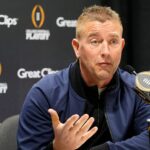 Kirk Herbstreit speaks at a press conference.