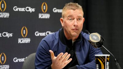Kirk Herbstreit speaks at a press conference.
